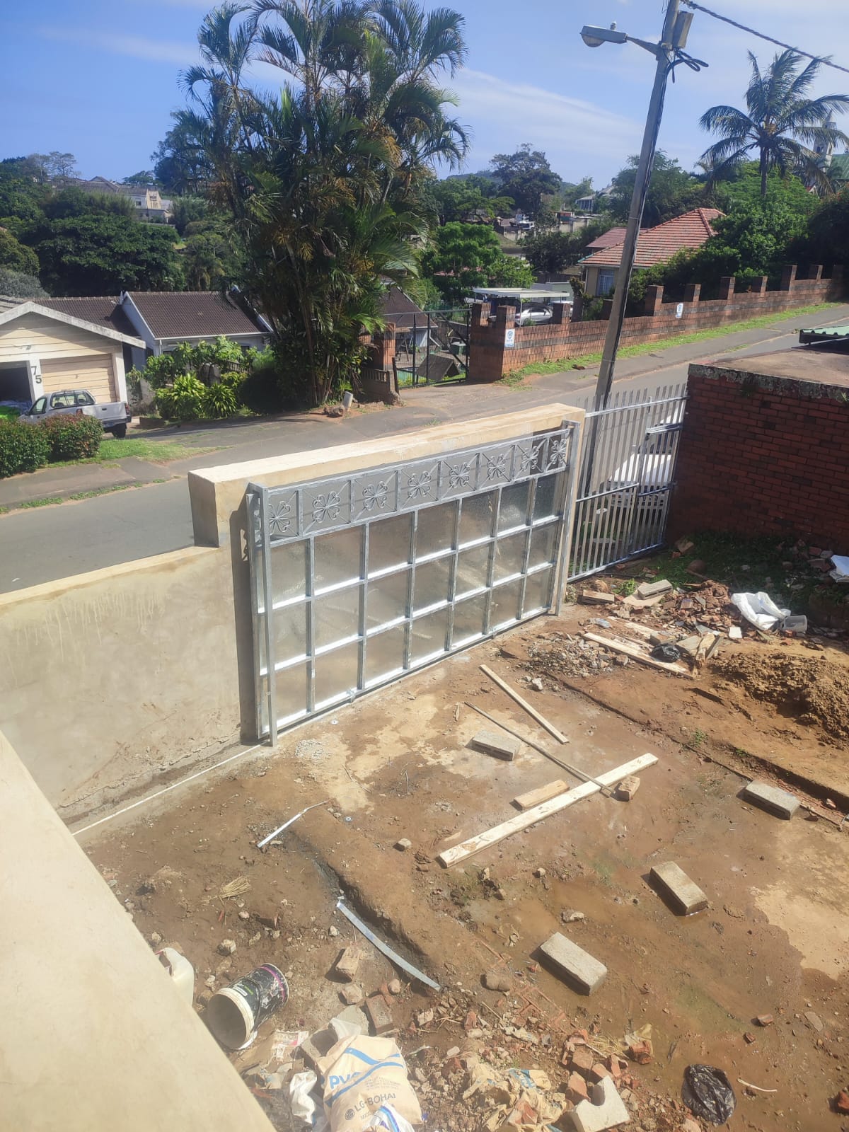 Modern steel and glass sliding driveway gate installation in a Durban suburb